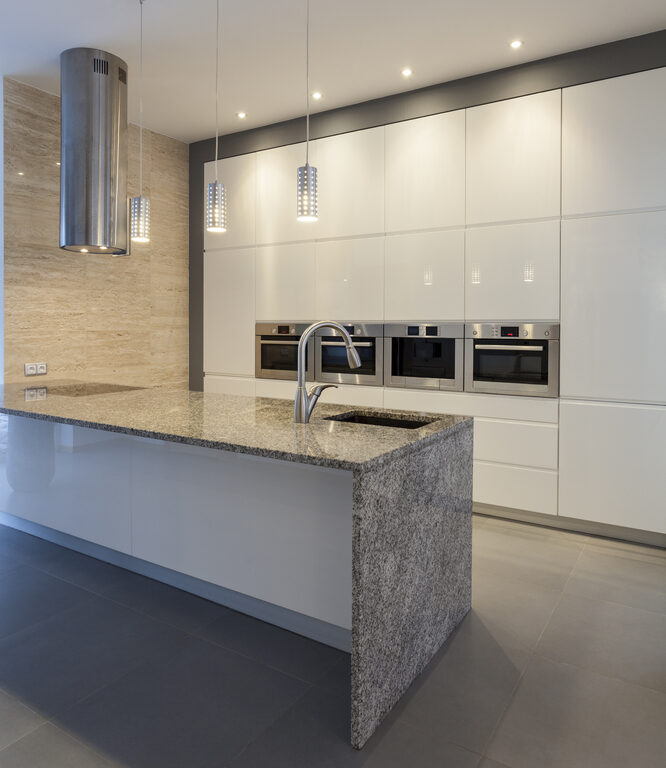 Designers interior -Kitchen in modern style with white and gray granite countertop with waterfall edge
