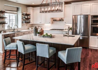 A modern kitchen featuring polished marble custom countertops by Advantage Stone. The large central island and surrounding counters showcase the craftsmanship, with a honed finish that highlights the natural beauty of the stone. The countertops provide a luxurious and functional surface that complements the overall design of the space, emphasizing Advantage Stone's expertise in custom counter solutions.